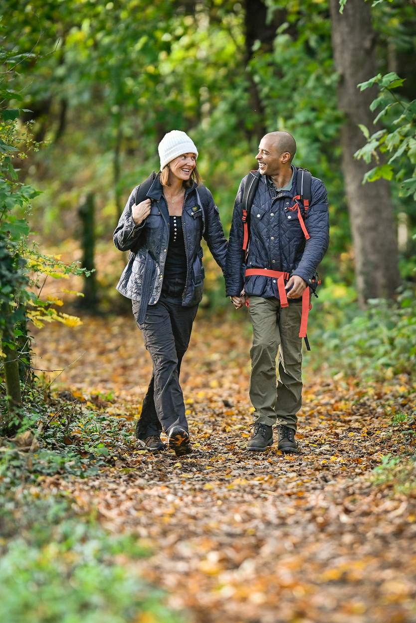 Couple walking on a path in the woods