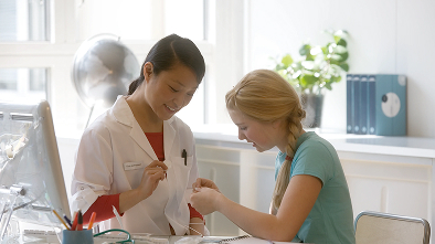 a woman showing a woman something on the paper